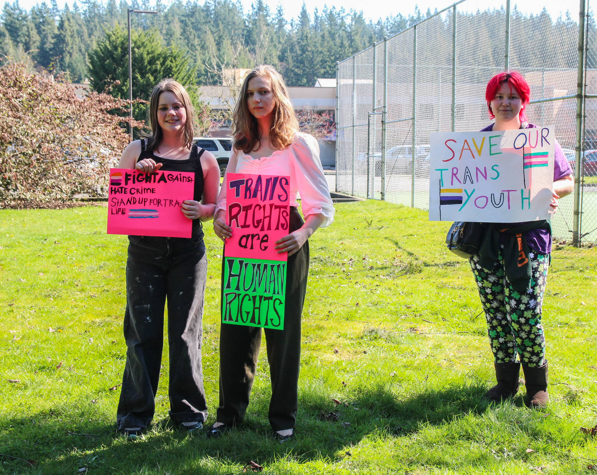 Photo by Luisa Loi
Two South Whidbey students hold signs by Maxwelton Road. Many of the protesters believe that, though Whidbey is far more accepting of LGBTQ+ communities than Oklahoma, students still experience bullying from their peers.
