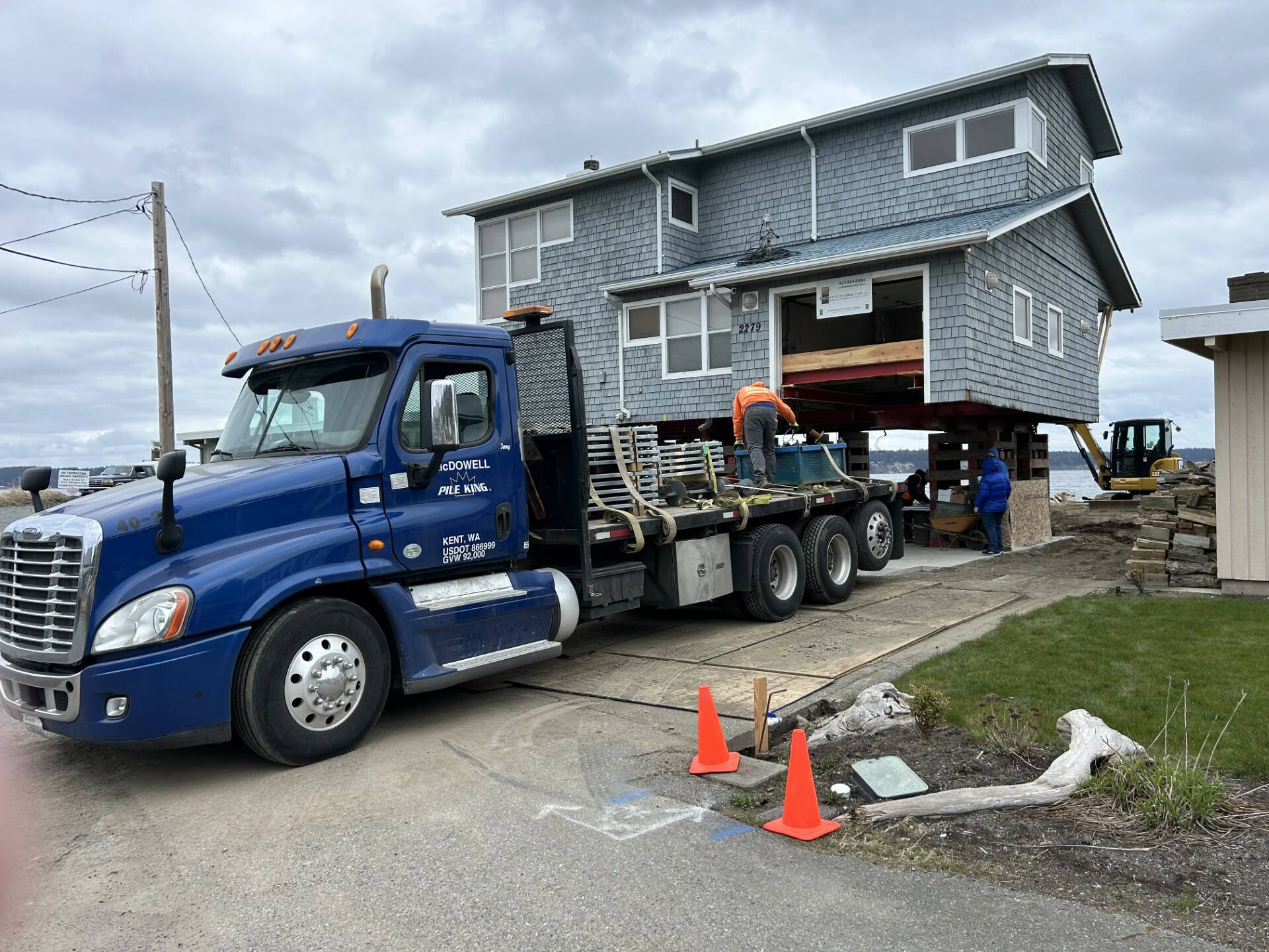 A truck brings in helical anchors to a Whidbey Shores property to pin the new foundation. (Photo courtesy of Reddan Construction)