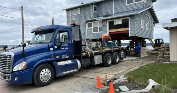 A truck brings in helical anchors to a Whidbey Shores property to pin the new foundation. (Photo courtesy of Reddan Construction)