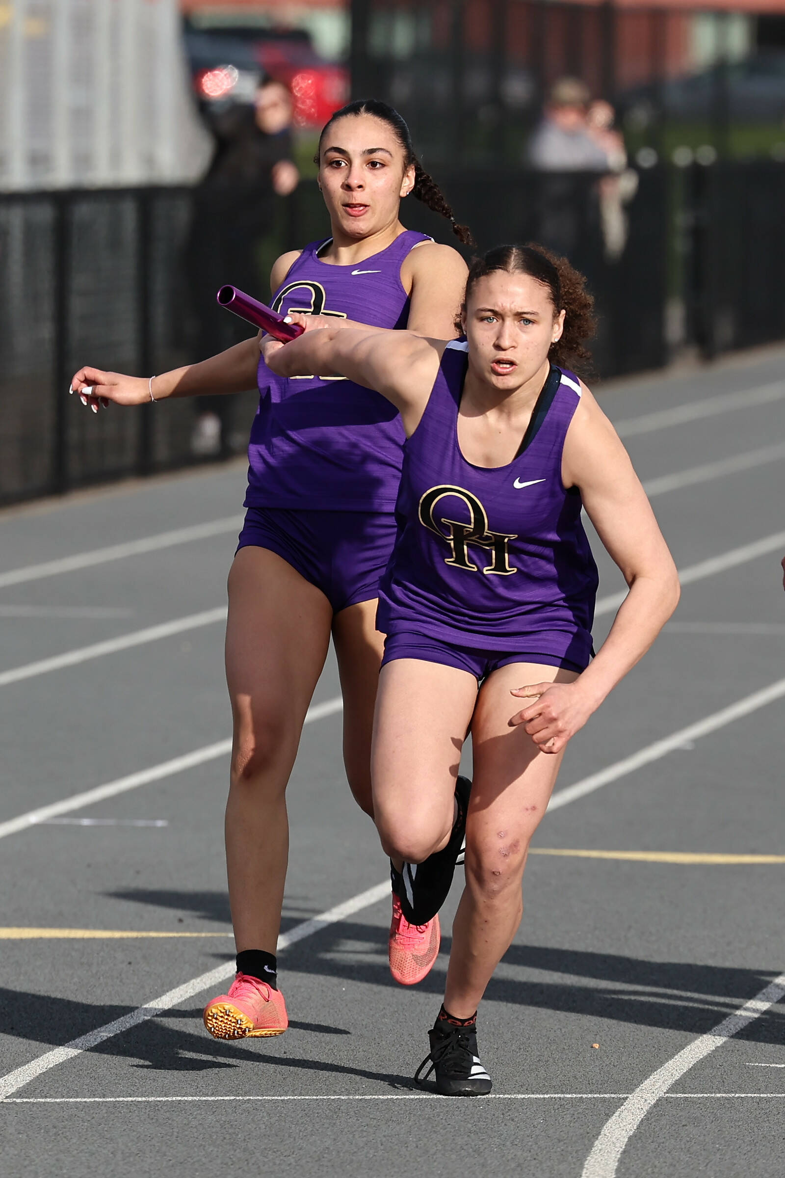 Jasmine Phillips, at left, and Bri Richard run a relay. (Photo by John Fisken)