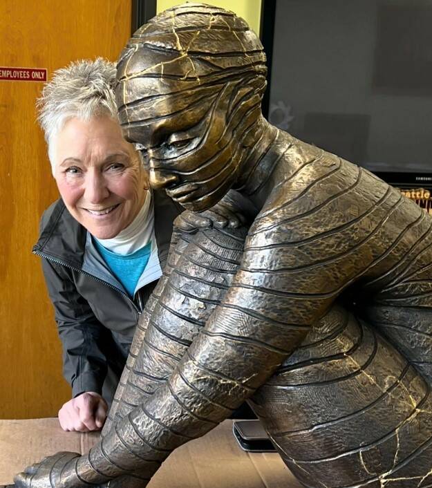 Photo provided
Maria Wickwire poses with the new “Anillos,” a bronze reproduction of her original ceramic sculpture. The gold lines, inspired by the Japanese tradition known as “kintsugi,” show where the original piece broke.