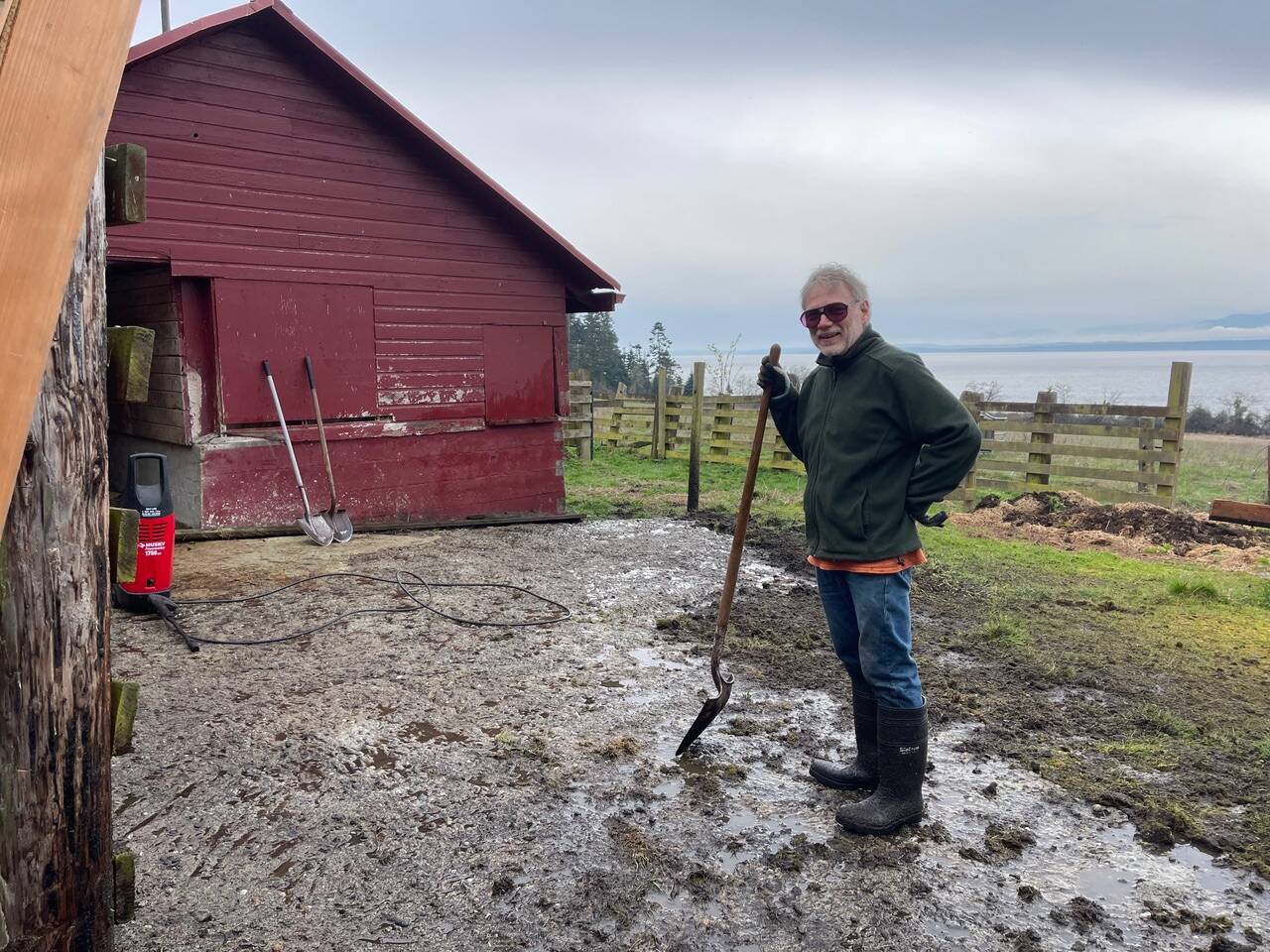 John Cordell takes a moment to appreciate the difference he and his pressure washer made on what was a completely moss- and grass-covered concrete pad. (Photo provided)