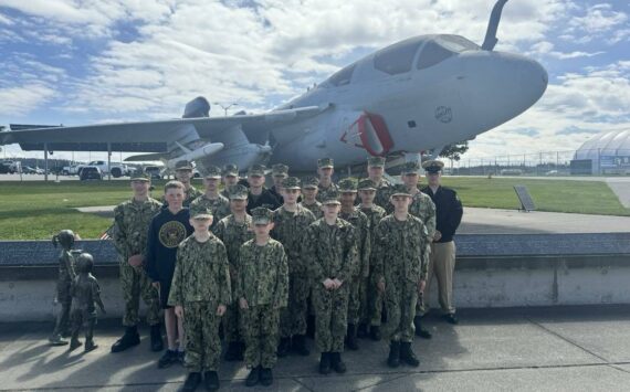 The Orion Squadron poses before a prowler on a VAQ-129 tour in 2022. (Photo provided)