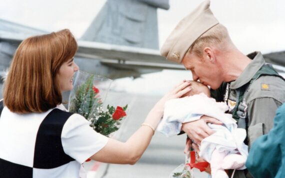 Randy Pierson meeting Alyssa, 1 month old, for the first time during the VAQ-137 Rooks Homecoming in 1998. (Photo Provided)
