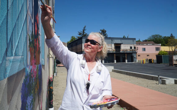 Paula Fries finishes her Serendipity Lane mural on Thursday. (Photo by Sam Fletcher)