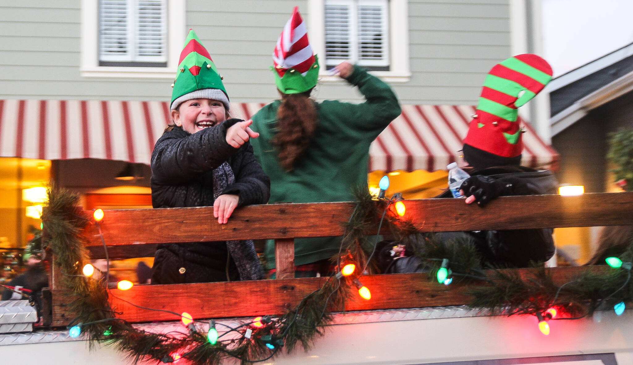 A rogue elf on Callens Christmas float throws candy at the crowd during a Christmas parade in Coupeville Saturday.