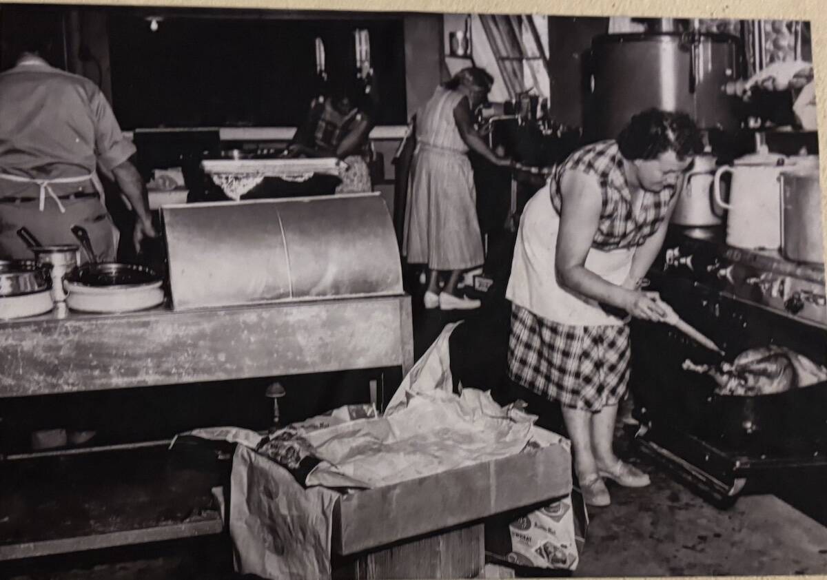 Whidbey Island Fair image
A woman bakes a turkey in the fair kitchen in 1956.