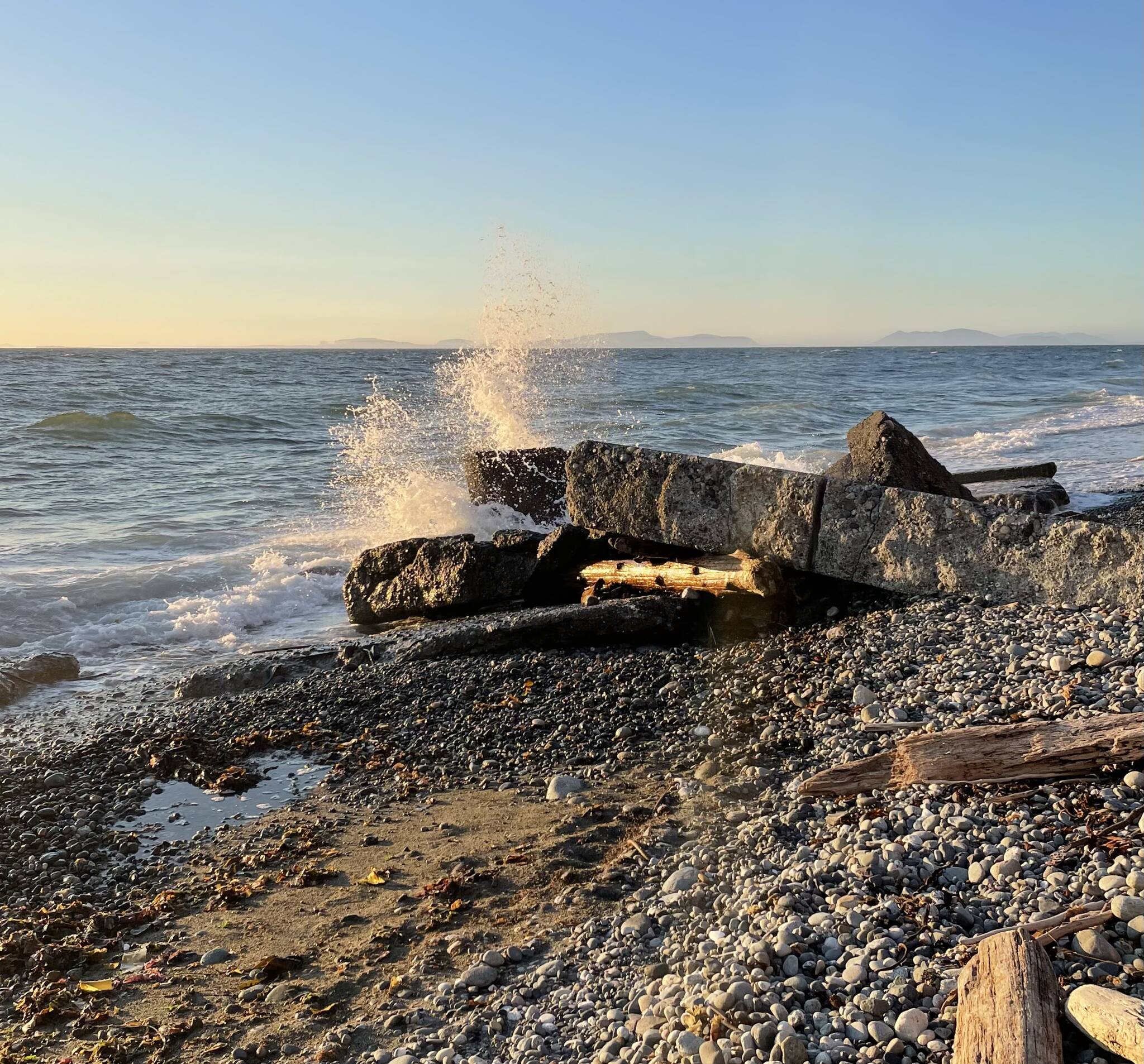 (Photo by Marina Blatt) A wave hits a rock at Point Partridge Tuesday evening, after a tsunami advisory on Whidbey.