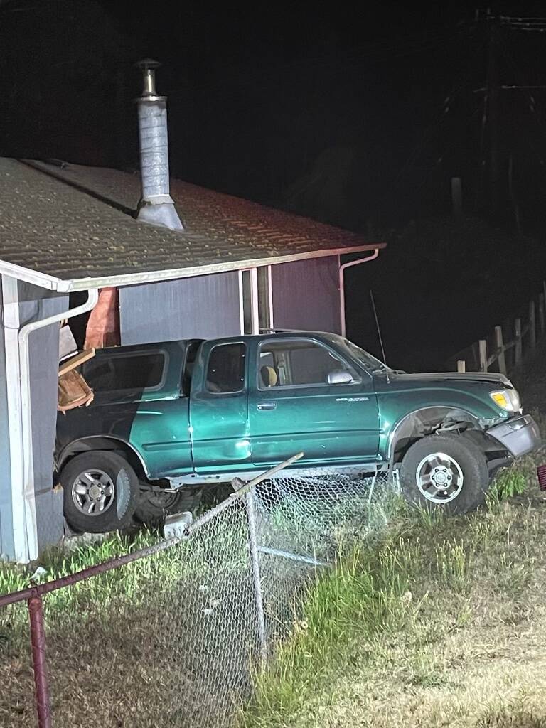 (Photo courtesy of NWFR) A pickup backed into a house on North Whidbey last year.