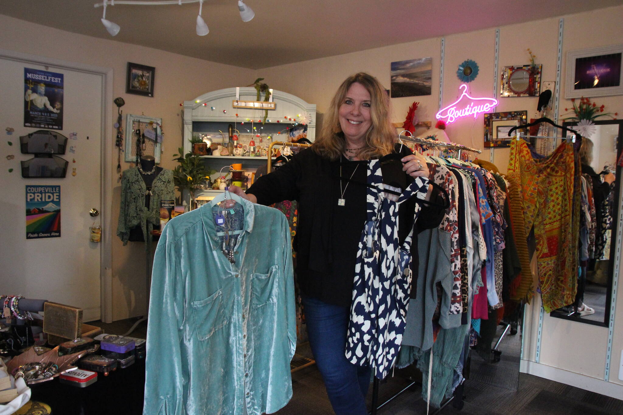 (Photo by Marina Blatt) Vicki Yount shows off the colorful clothing she sells in V-Boutique.