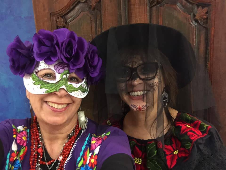 Suzanne Ashworth and Naomi Schneider wear Halloween masks at Fridas.
