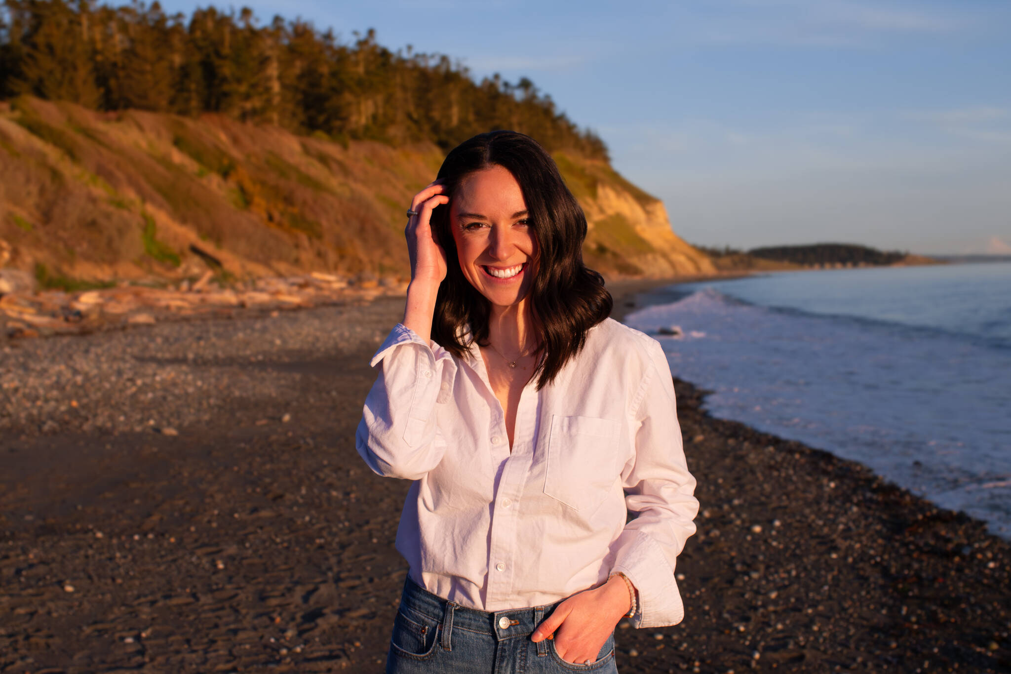 (Photo provided) BreAnne Daly, owner of Under the Evergreens LLC, that runs @explorewhidbeyisland on Instagram, smiles at Ebeys Landing beach.