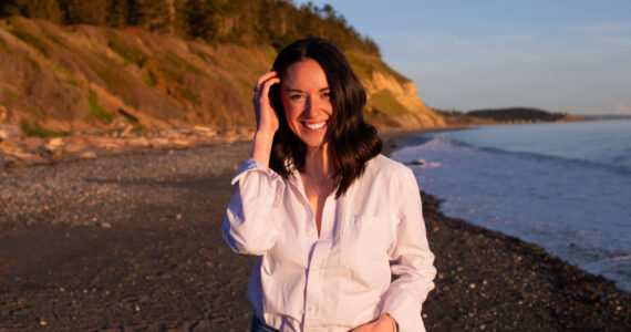 Photo provided
BreAnne Daly, owner of Under the Evergreens LLC, the largest tourism account on Whidbey, smiles at Ebey's Landing beach.