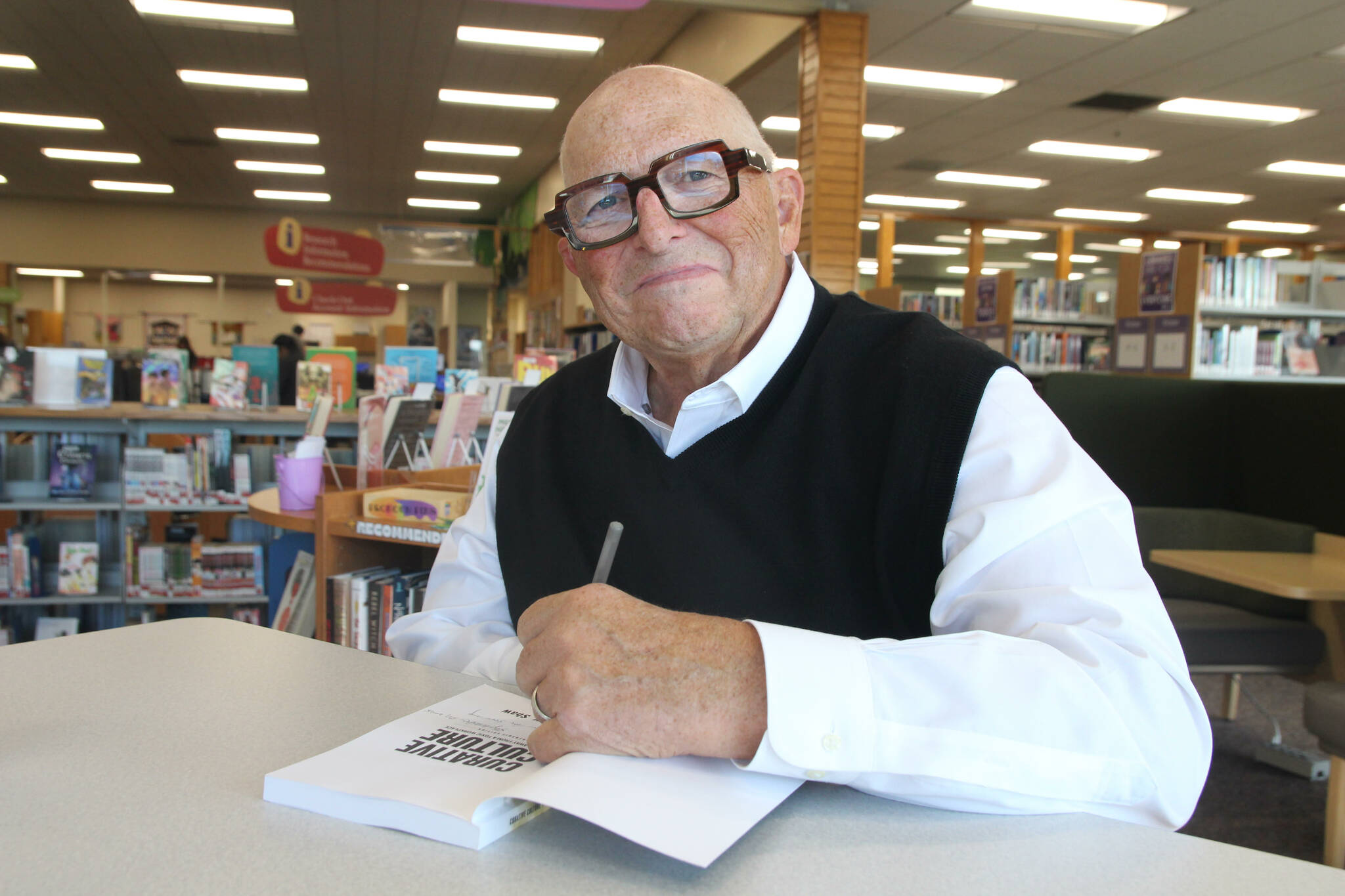 Douglass Shaw signs a copy of his latest book, Curative Culture. (Photo by Marina Blatt)