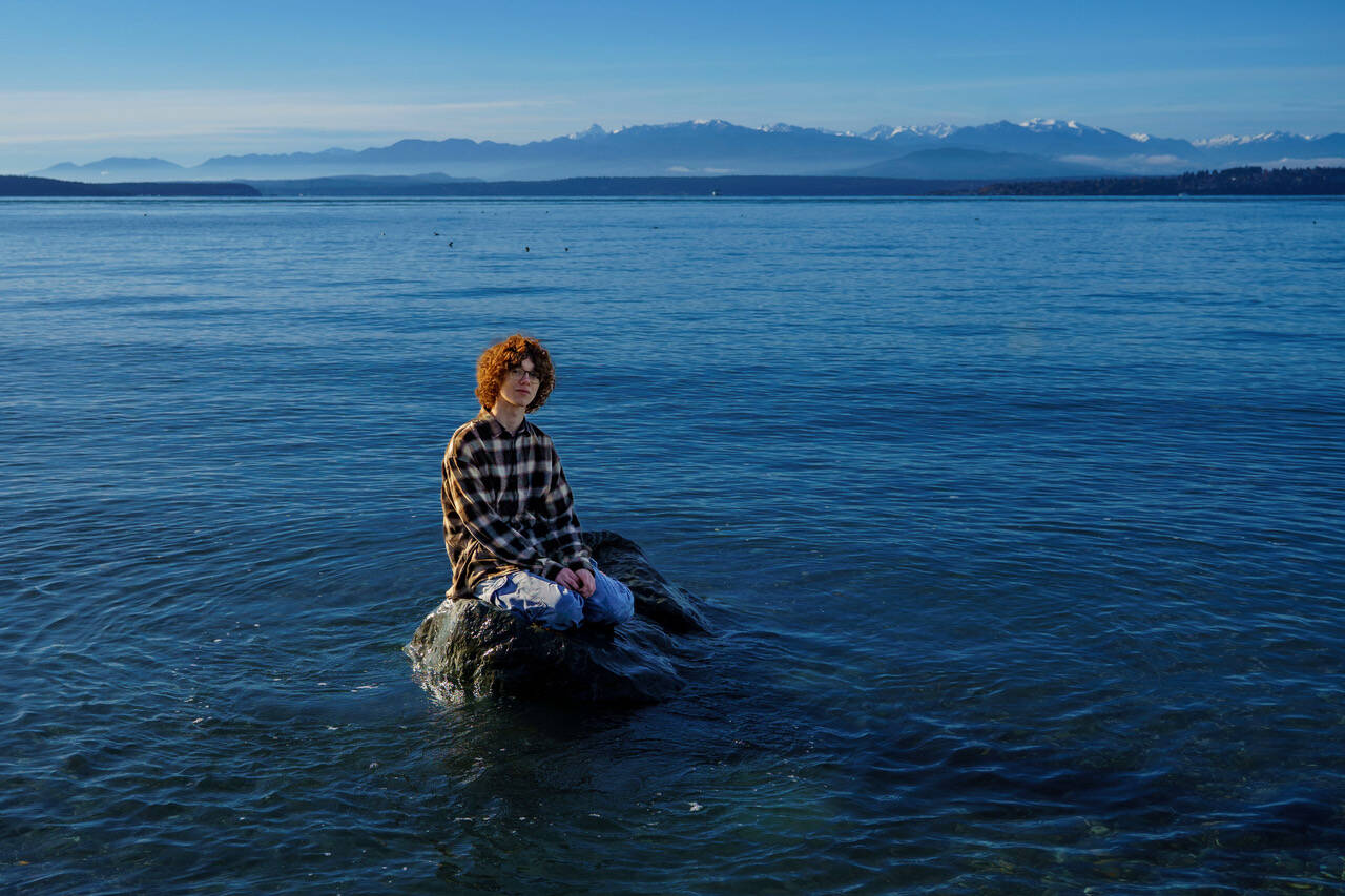 Seventeen-year-old Owen Roberson chills on a rock far out in the water off of Fort Casey State Park on Central Whidbey on Saturday. The weekend was unseasonably warm and sunny, but cool and wet weather returned this week with a vengeance. Temperatures with lows in the 40s and rain nearly every day in predicted.