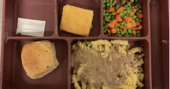 A meal tray from Island County Jail has beef gravy over noodles with mixed vegetable, corn bread and garlic roll.