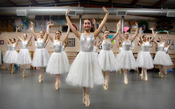 Photo by Marina Blatt. Dancers wear white dresses while standing on pointe, with Hannah Brackeen, age 15, in the role of Clara, at the front.