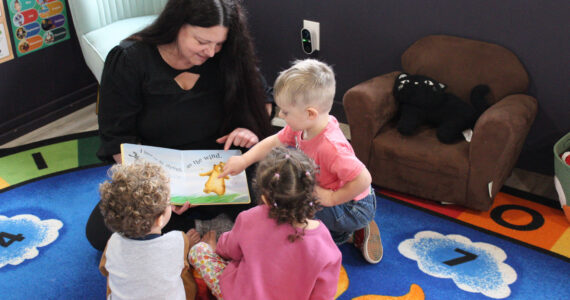 Ashley Bernales reads a book to Weston, Xayla and Waylon. (Photos by Sarah Bellis)