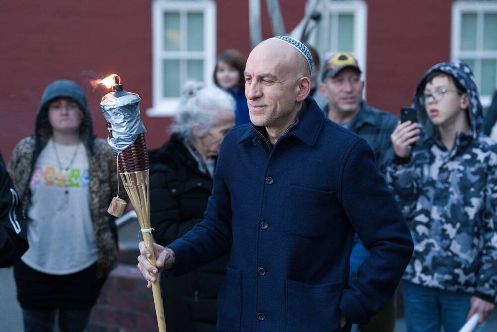 (Photo provided by the Chabad Jewish Center of Skagit County) A man prepares to light the giant menorah with a giant torch, of course.
