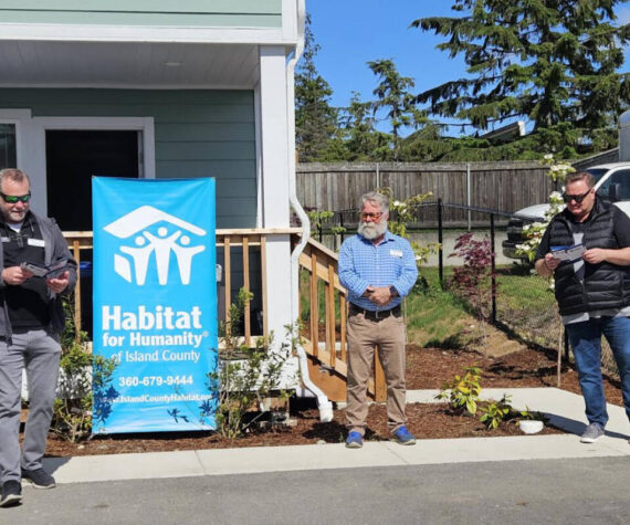 <p>From left: Orin Kolaitis - CEO, Scott Givens – Chief Program Officer, Mayor Ronnie Wright – Oak Harbor at a home dedication. Photo courtesy Habitat for Humanity of Island County</p>