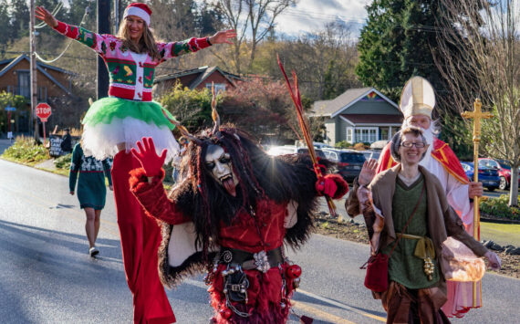 Photo by David Welton 
Lady Klinkerbell Krampus, Whidbey Island’s very old Krampus, walked along with Saint Nick, a long-legged elf and many other creative characters during the Holly Jolly Parade in Langley Saturday. While Lady Klinkerbell Krampus may look scary, she’s part of a Northern European tradition that celebrates whimsy and the mischievous side of the holidays, according to the Whidbey Island Fair website. The Langley parade was one of several community events held on Saturday to welcome the Christmas season.