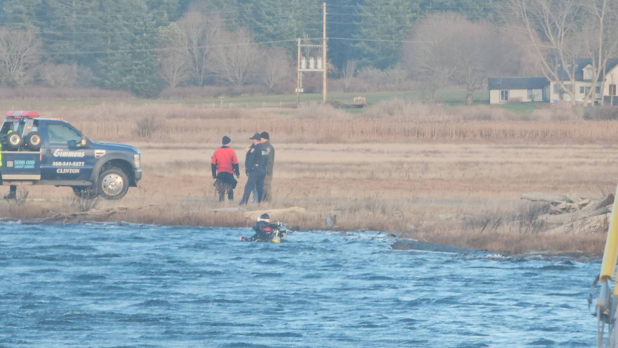 Photo by Mel Nasby. Divers aided in the recovery of the vehicle the day after the crash.