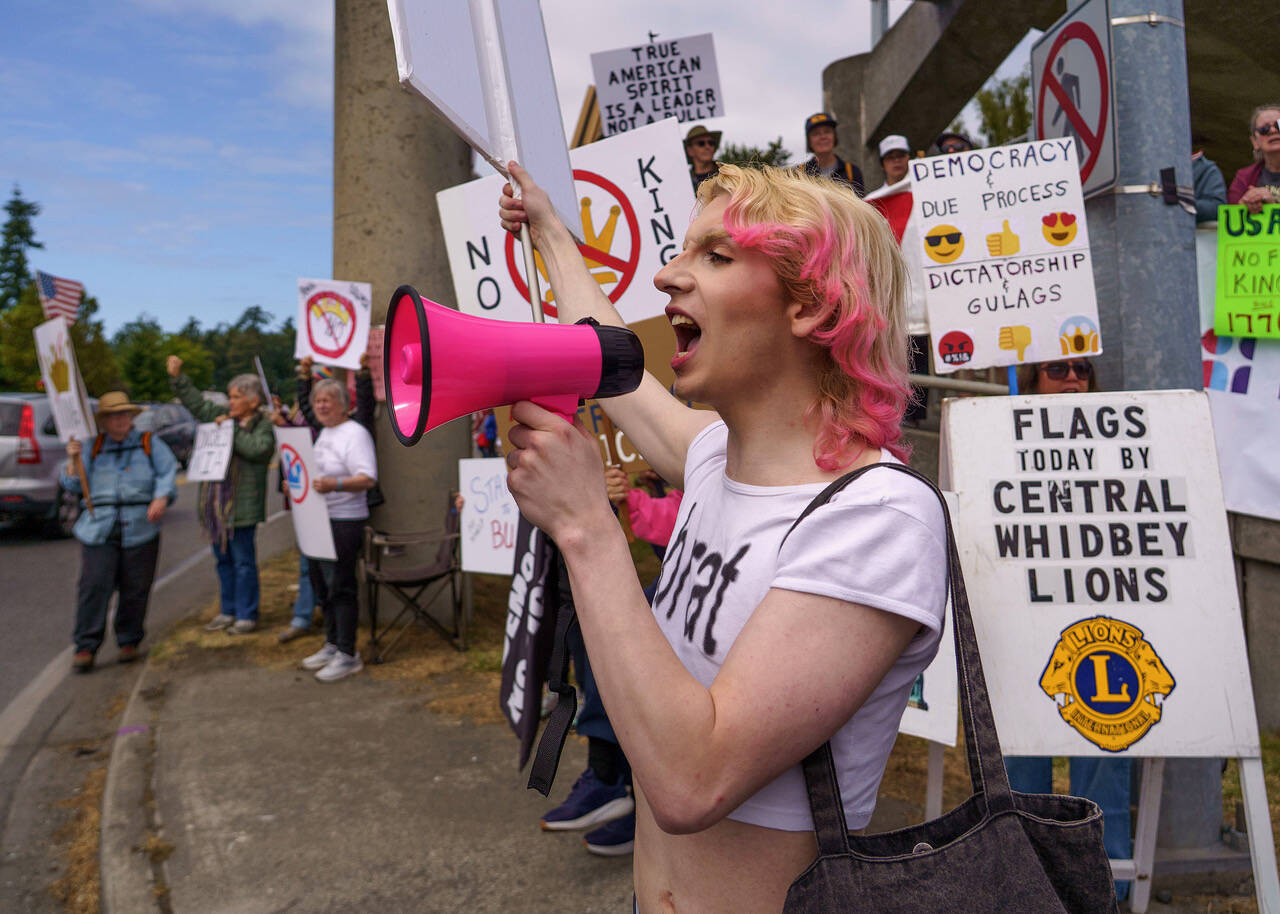 (Photo by David Welton) River Clark led the crowd in a chant at the No Kings protest in Coupeville in June.