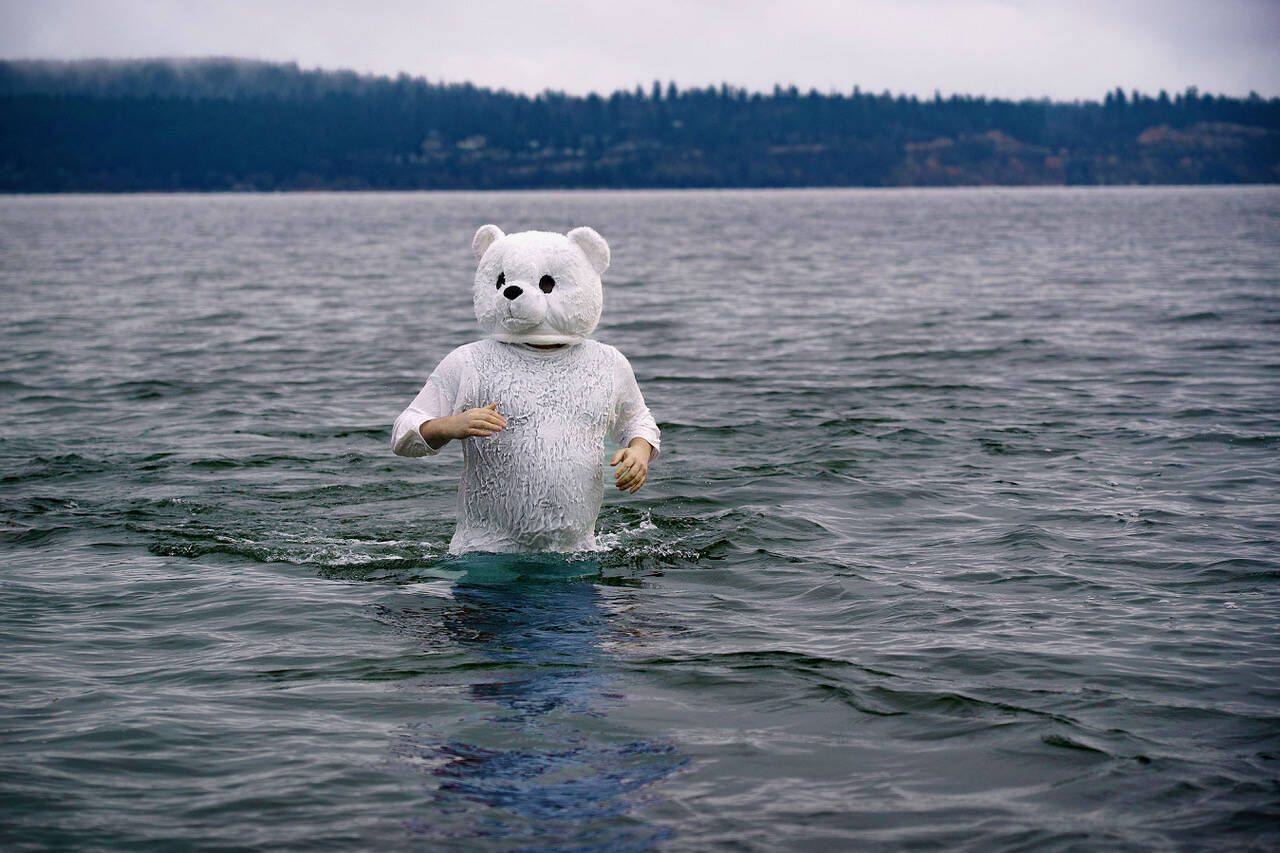 (Photo by David Welton) Kustaa Mansfield got into the spirit by donning a polar bear suit. While some only stayed in the water for about 10 seconds, he lingered and enjoyed the icy atmosphere.