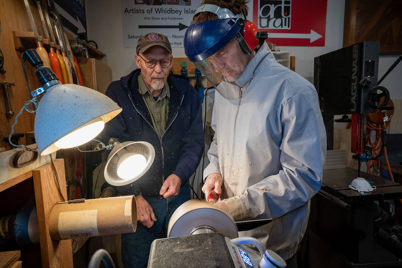 Photos by David Welton. Don Wodjenski, left, shows Nathan Welton how to turn a wooden bowl on his lathe. Wodjenski is open to teaching more people who are interested in learning.