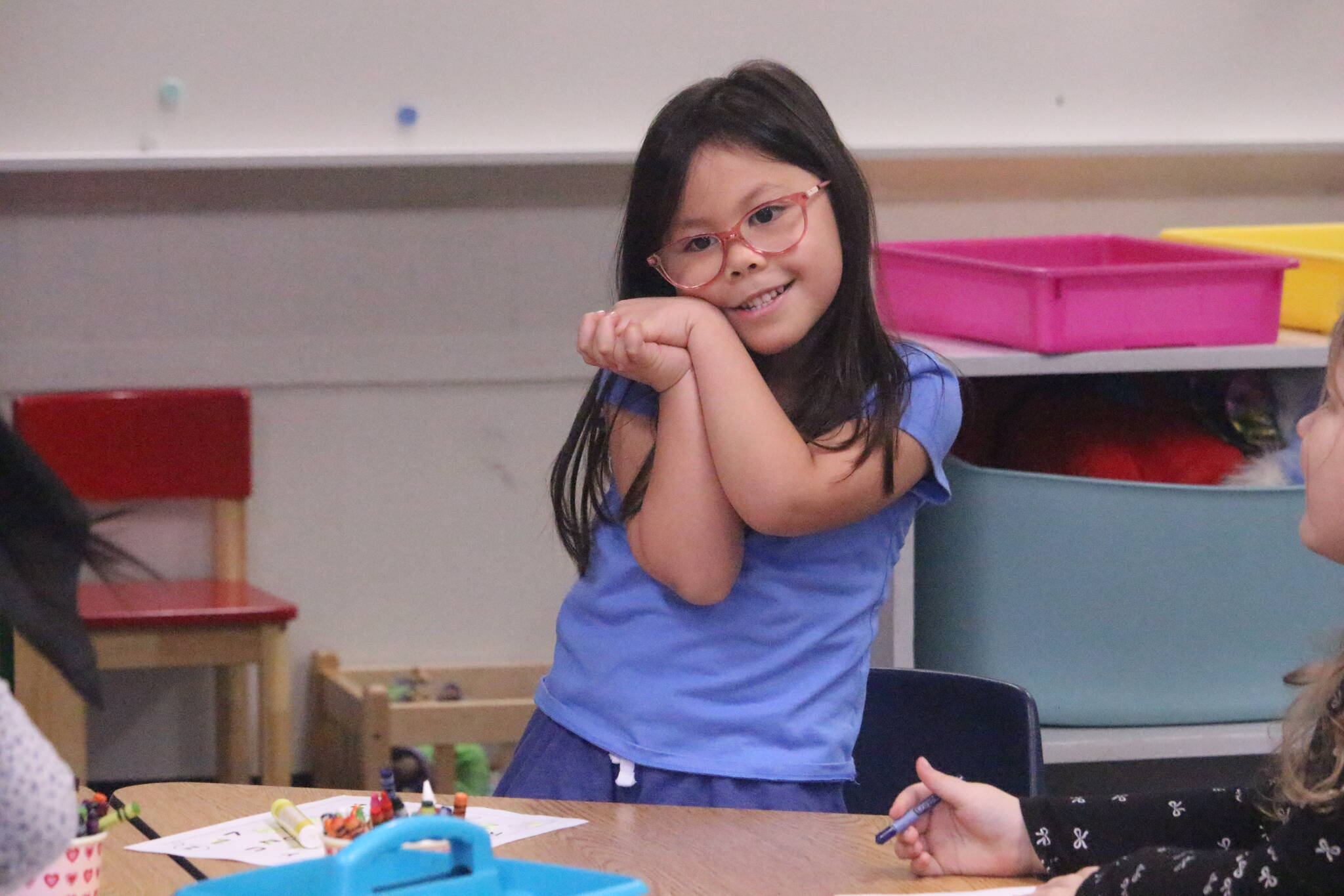 Photo by Marina Blatt. Students in Olympic View Elementary paused their coloring activity to admire the surprise therapy dog visitors.