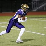 TJ Hollins-Passmore races for more yardage in Oak Harbor&rsquo;s win Friday. (Photo by John Fisken.)