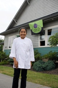 June Blouin proudly stands outside of her new business