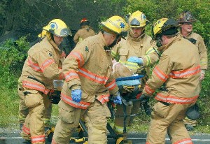 North Whidbey Fire and Rescue firefighters secure an Oak Harbor woman for transport to Whidbey General Hospital Friday