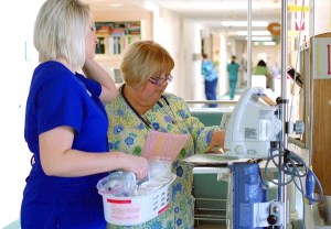 Registered Nurse Jeanne Cox and student intern Jenna Ure work in Whidbey General Hospital’s medical surgical wing. On Monday
