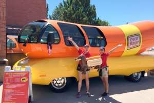 Taylor Lennox (left) and Mayra Martinez drive one of six Wienermobiles that travel throughout the United States for Oscar Mayer.