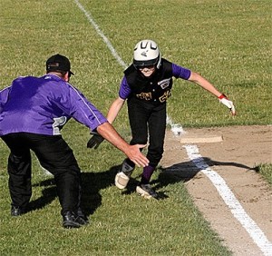 North Whidbey third base coach Kevin Rhew celebrates with Will Rankin as Rankin rounds the bases after hitting a home run.