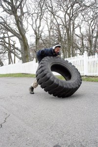 Petty Officer Michael McCastle flips a tire Saturday