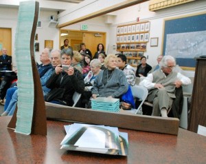 A miniature model of a stacked glass art piece sits on display at one of the many public meetings the Arts Commission held in recent months in order to pick four pieces for Pioneer Way.