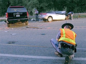 Troopers from the Washington State Patrol investigate a car accident on Highway 20 near the intersection with Jones Road that killed an Anacortes man Thursday evening.