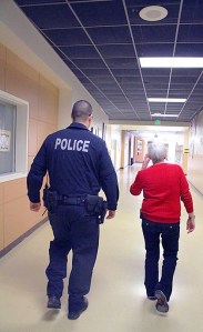 Police officer Nathan Padrta and Oak Harbor High School dean Pat Felger walk the halls between classes.