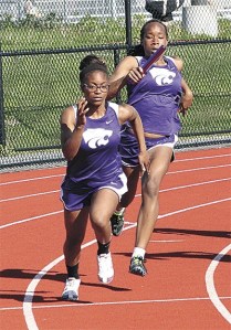 Oak Harbor's Janae Payne passes the baton to Priya Osborne in the 4x100 relay Thursday.