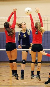 Oak Harbor's Hailee Blau (6) splits the block of Mountlake Terrace's Alisha Clingan