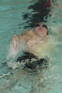 Toren Wood helps Oak Harbor win the 200 medley relay against Monroe Monday.