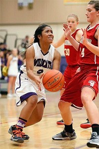 Rashanna Graham tries to slip by the defense of Stanwood's Jillian Heichel.