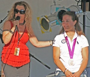 Janie Cribbs of the band Tambourine Sky sings to Olympic champion Marti Malloy at the start of the Oak Harbor Music and Jazz Festival.