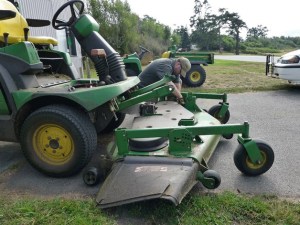 Fort Casey Park Aide Chris Bailey tends to a riding lawn mower. Washington State Parks officials are asking the state for $18 million to help pay for park operations.