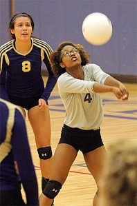 Oak Harbor's Priya Osborne passes as AnnaBelle Whitefoot looks on in the Wildcats' win Tuesday.