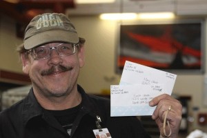 Dan Miller holds up two letters to Santa he recently received at the Oak Harbor post office. He said he routes them accordingly.