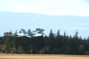 An EA-18G Growler ascends after a touch-and-go at OLF.