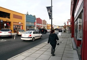 A shopper in downtown Oak Harbor braces against strong winds Thursday afternoon. Merchants and officials hope the city’s newly received Main Street status will increase foot traffic and draw tourists.